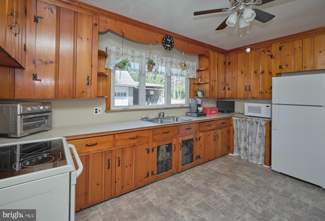 kitchen with white appliances, open shelves, a toaster, a sink, and brown cabinets