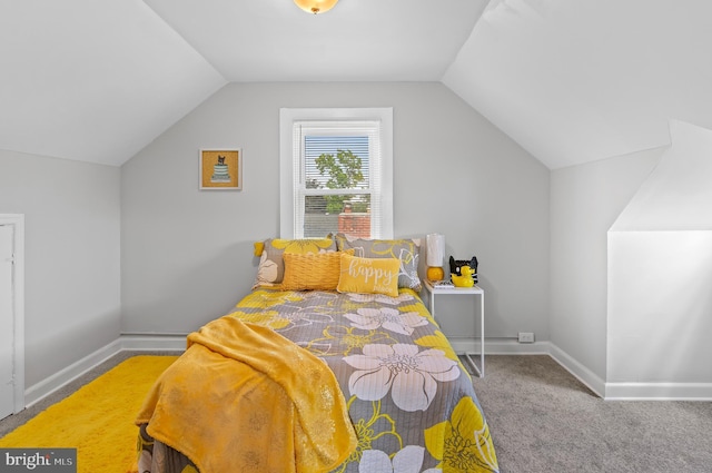 bedroom with carpet floors, baseboards, and vaulted ceiling