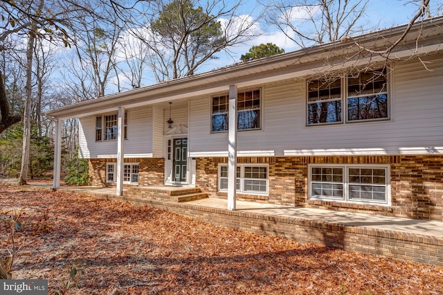 split foyer home featuring brick siding