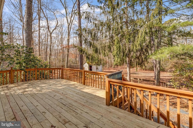 wooden deck with an outdoor structure and a shed