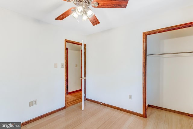 unfurnished bedroom with a ceiling fan, baseboards, a closet, and light wood finished floors