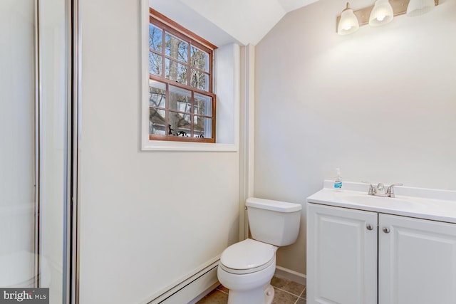 bathroom featuring vanity, lofted ceiling, tile patterned flooring, a baseboard heating unit, and toilet