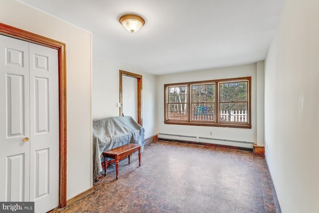 interior space with a baseboard heating unit and baseboards