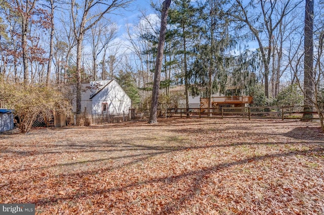 view of yard featuring a wooden deck and fence