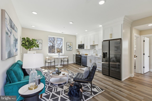 living room with recessed lighting, baseboards, and wood finished floors