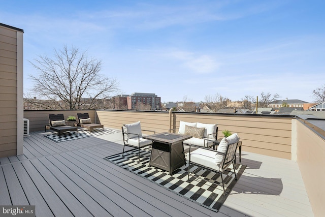 deck with an outdoor living space with a fire pit