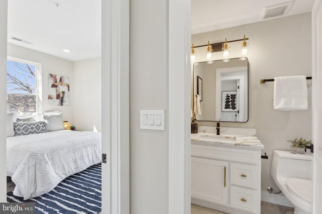 bathroom with visible vents, toilet, and vanity