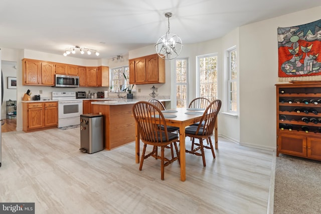 dining room featuring baseboards and an inviting chandelier