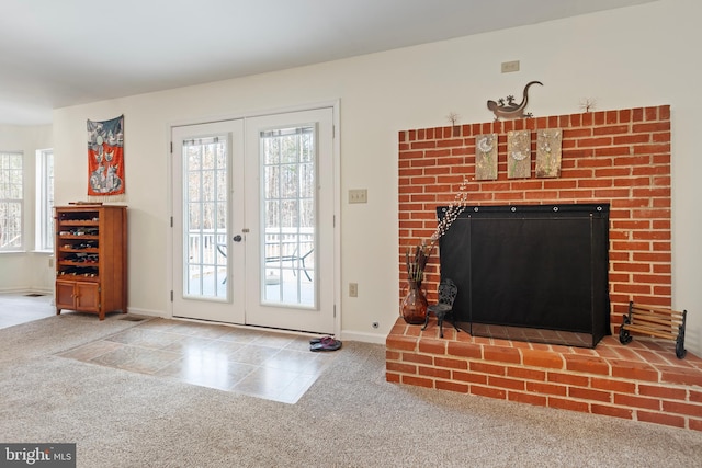 carpeted living area featuring tile patterned floors, french doors, a fireplace, and baseboards