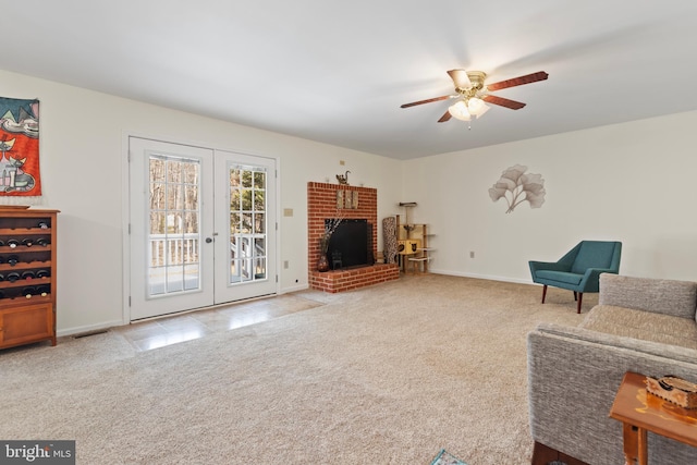 carpeted living room with french doors, baseboards, and ceiling fan