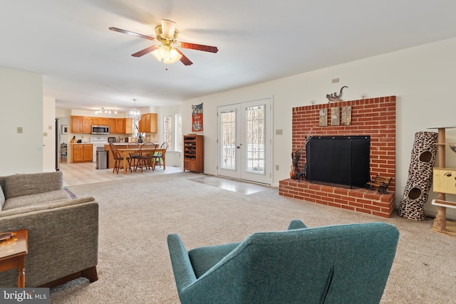 living area with light colored carpet and ceiling fan