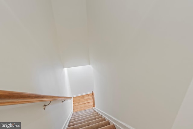 staircase featuring baseboards