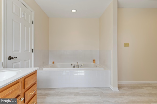 bathroom featuring a bath and vanity