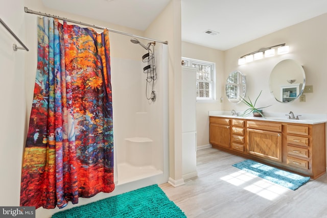 full bathroom with double vanity, visible vents, a shower with curtain, and a sink