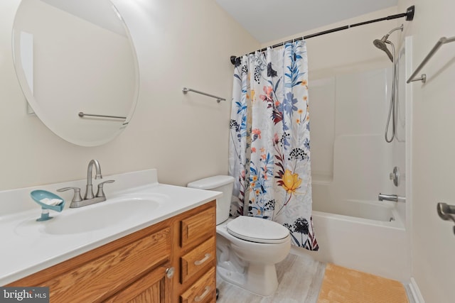 bathroom featuring shower / bath combo with shower curtain, toilet, and vanity