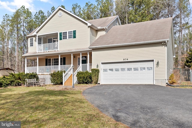 traditional-style house featuring a front lawn, aphalt driveway, a porch, a garage, and a balcony