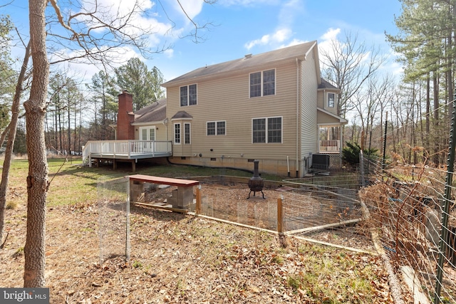 back of property featuring a deck, crawl space, central AC unit, and a chimney