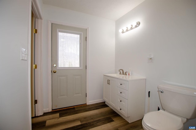 bathroom featuring vanity, toilet, and wood finished floors