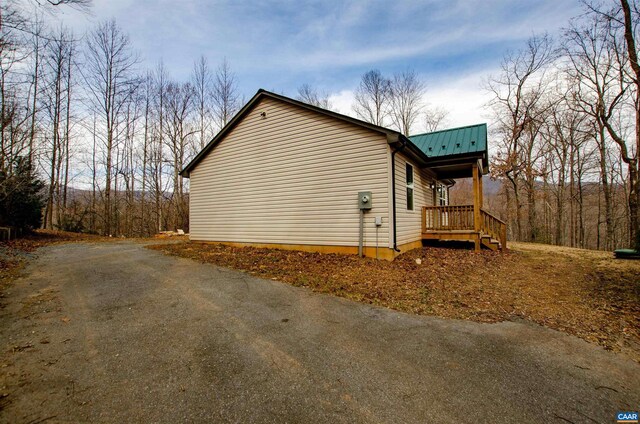 view of property exterior featuring metal roof