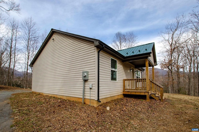 view of side of home with metal roof