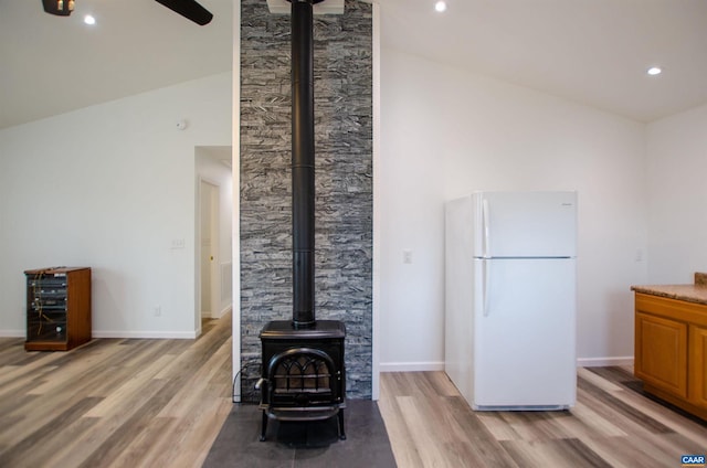 living area featuring recessed lighting, baseboards, and light wood finished floors