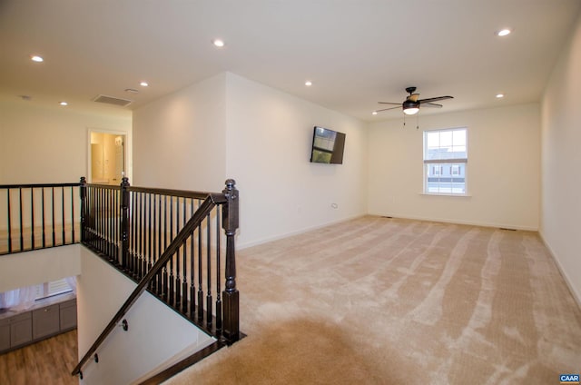 unfurnished room with a ceiling fan, visible vents, baseboards, recessed lighting, and light colored carpet