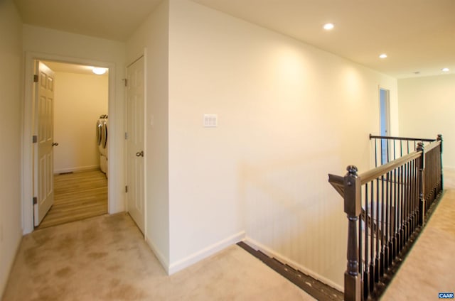 corridor featuring baseboards, recessed lighting, washer and dryer, carpet flooring, and an upstairs landing