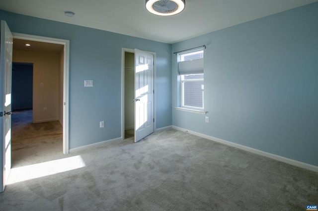 unfurnished bedroom with visible vents, baseboards, and carpet flooring