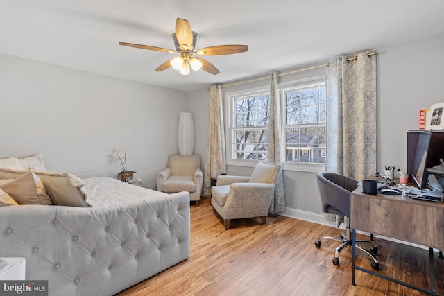 bedroom featuring a ceiling fan, wood finished floors, and baseboards