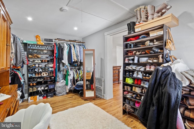 spacious closet featuring attic access and wood finished floors