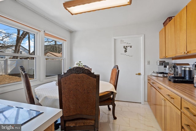 dining space with marble finish floor