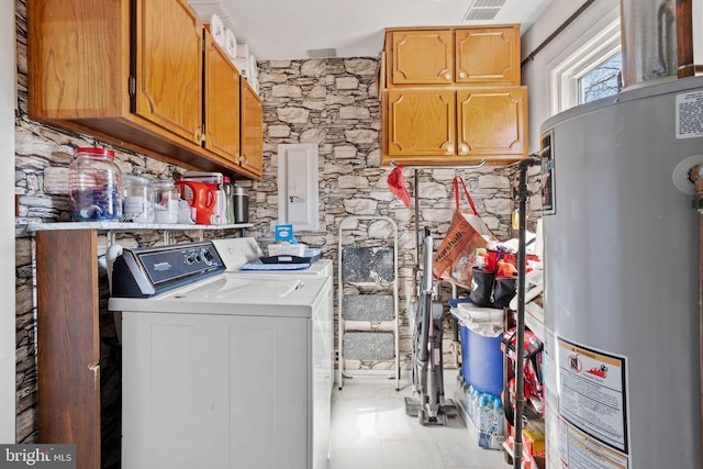 laundry area with visible vents, washer and clothes dryer, electric panel, gas water heater, and cabinet space