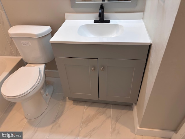 bathroom featuring marble finish floor, vanity, and toilet