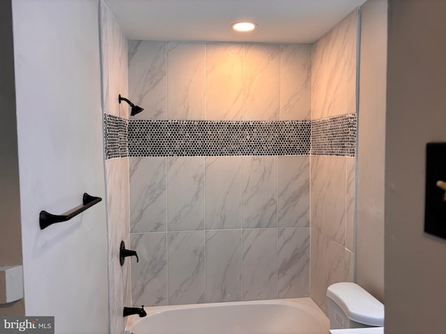 bathroom with bathing tub / shower combination, toilet, and recessed lighting