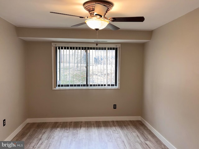 empty room with light wood-style floors, baseboards, and ceiling fan