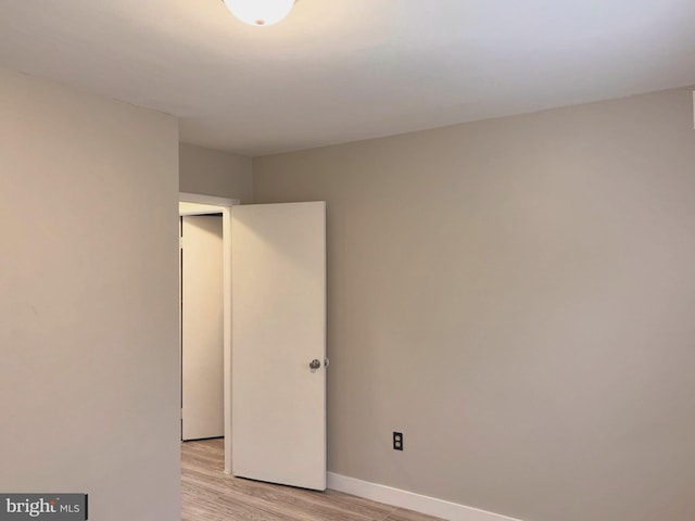 unfurnished bedroom featuring baseboards and light wood-style floors