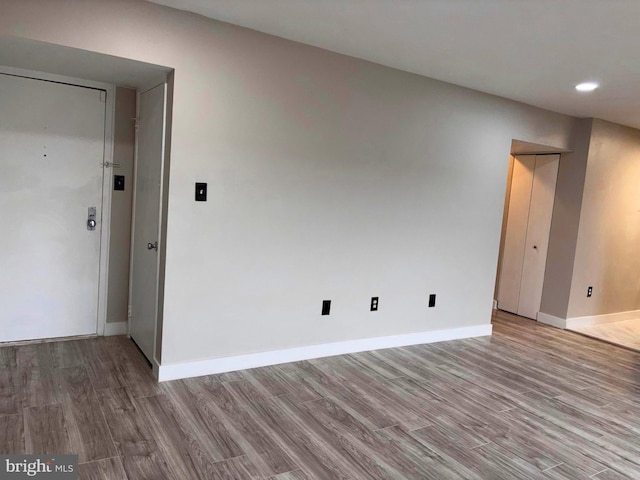 empty room with baseboards and wood finished floors