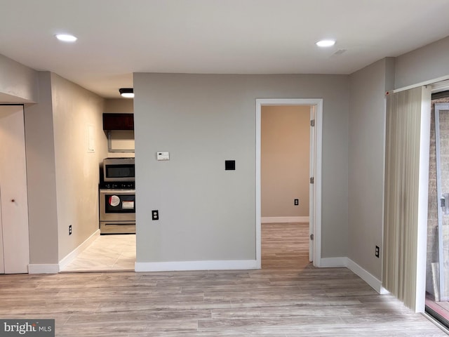 interior space featuring light wood-style flooring, recessed lighting, and baseboards