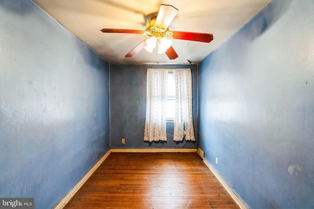 empty room featuring baseboards, ceiling fan, and hardwood / wood-style flooring