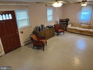 interior space featuring a baseboard heating unit and a ceiling fan