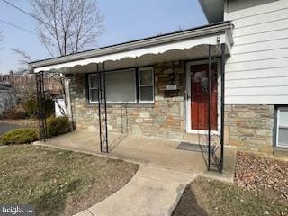 doorway to property with stone siding