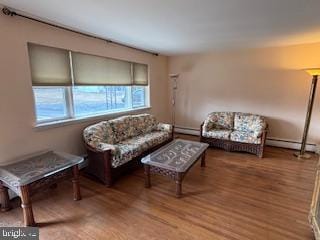 living area with a baseboard radiator and wood finished floors