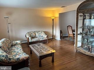 living area featuring baseboard heating and wood finished floors