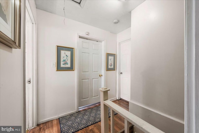 mudroom featuring attic access and wood finished floors