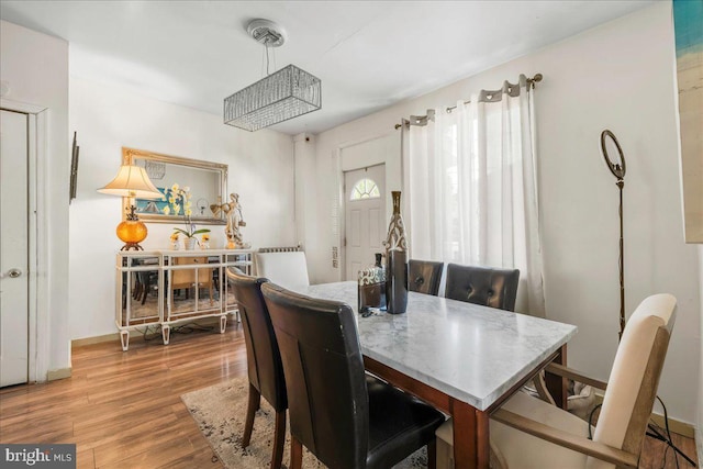 dining room with baseboards and wood finished floors