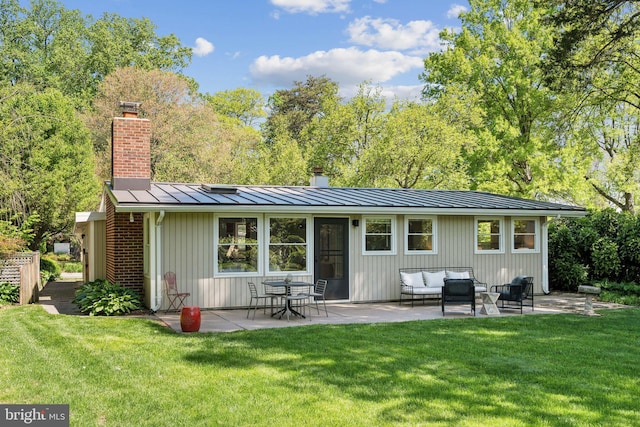 7711 Holmes Run Dr, Falls Church, VA 22042 - rear view of property with a standing seam roof, a chimney, an outdoor living space, a yard, and a patio