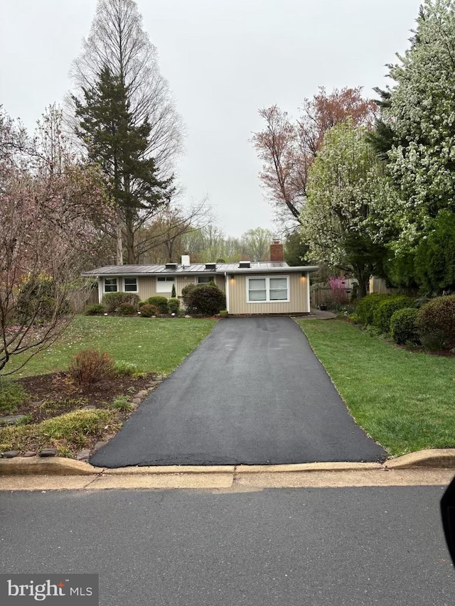 7711 Holmes Run Dr, Falls Church, VA 22042 - ranch-style home featuring a chimney, aphalt driveway, and a front yard