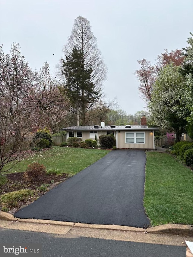 7711 Holmes Run Dr, Falls Church, VA 22042 - ranch-style house featuring driveway, fence, a front yard, and a chimney