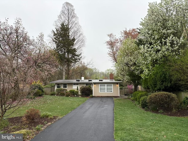 7711 Holmes Run Dr, Falls Church, VA 22042 - single story home featuring fence, a chimney, a front yard, and aphalt driveway