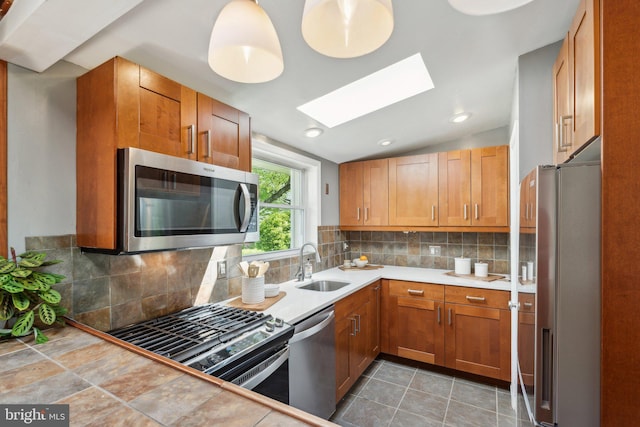 7711 Holmes Run Dr, Falls Church, VA 22042 - kitchen with brown cabinetry, a sink, appliances with stainless steel finishes, and light countertops